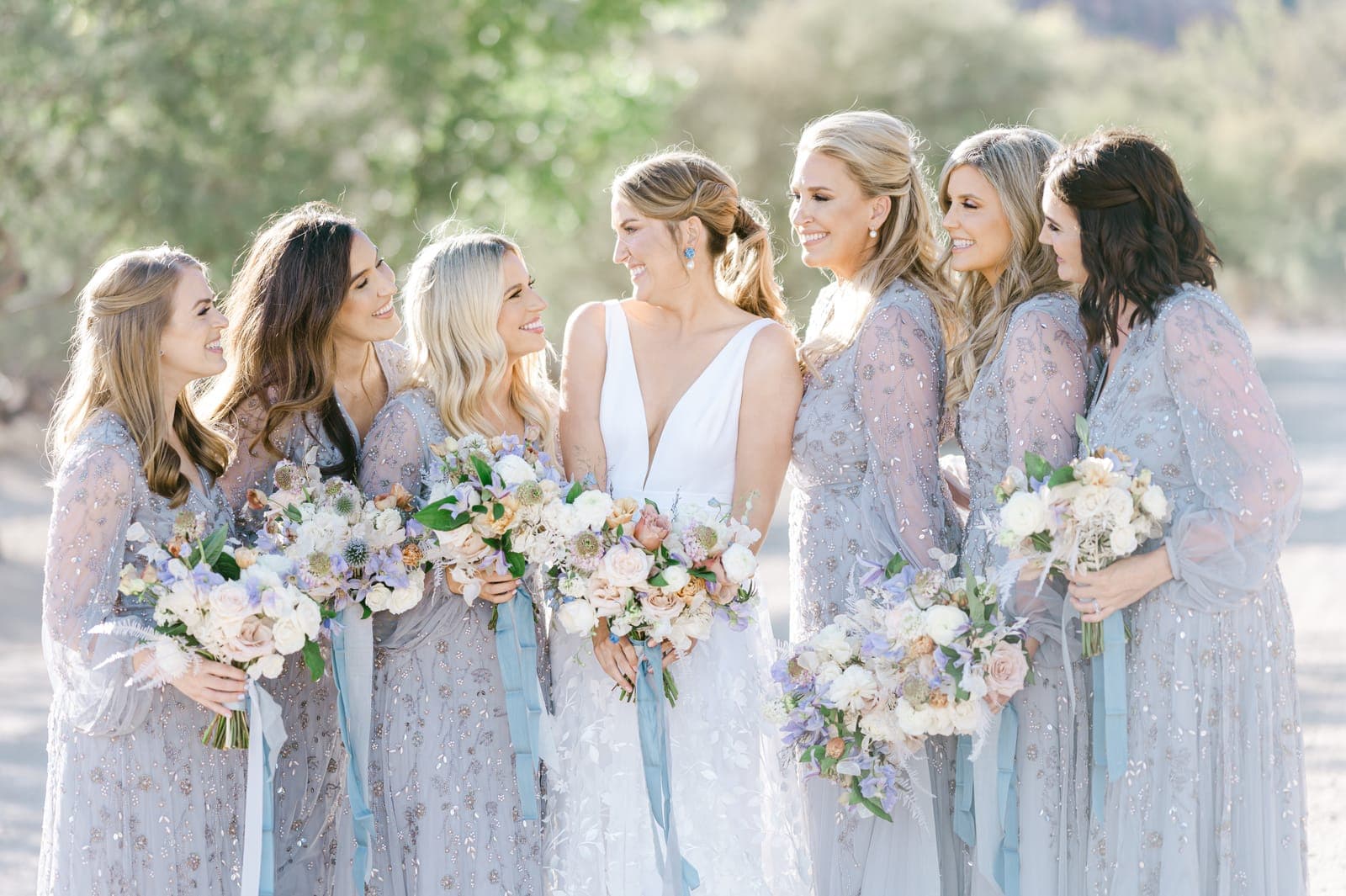 Bridesmaids laughing together before a Scheme wedding beneath Red Rock